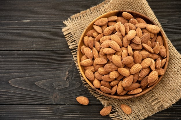 almond-wooden-bowl-wooden-background-near-bag-from-burlap-healthy-food-snack-organic-vegetarian-food